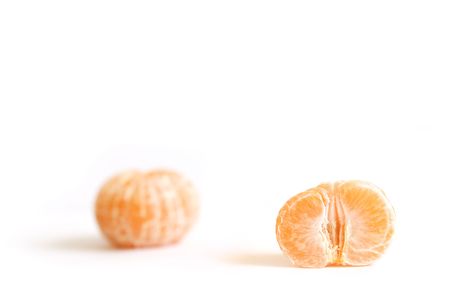 Two peeled orange mandarin, isolated on white backgroundの写真素材