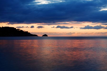View of sea at sunrise from Taormina, Sicily; soft water on foreground due to a long exposure.の写真素材