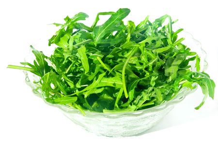 Fresh rocket salad in a glass holder, isolated on white backgroundの写真素材