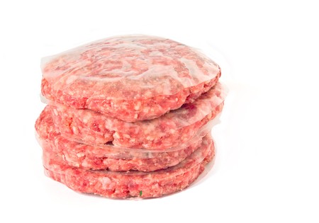 A Pile of Raw hamburgers isolated on white backgroundの写真素材