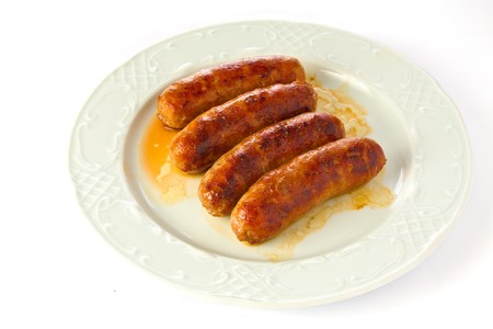 Grilled Sausages on a plate, isolated on white backgroundの写真素材