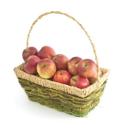 Several Red Apples in a basket, isolated on white backgroundの写真素材