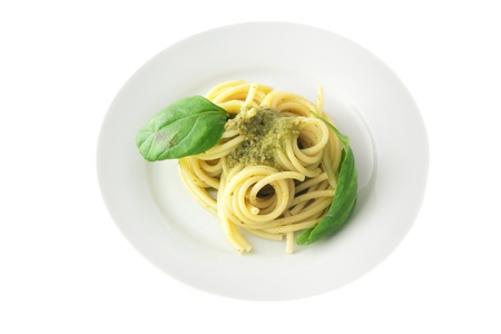 Spaghetti pasta with pesto sauce isolated on white backgroundの写真素材