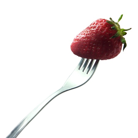 Strawberry on a fork isolated on whiteの写真素材