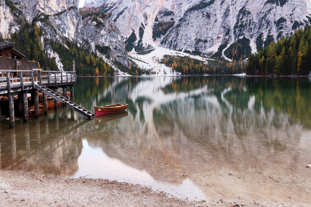 Lonely boat on a beautiful alpine lake (photo taken in Braies Lake, Italy).のeditorial素材