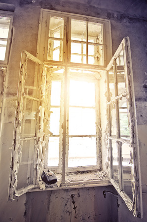 sun shining through an old window in an abandoned buildingの写真素材