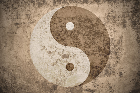 yinyang symbol on a grungy vintage texture with stains, scratches and wrinklesの写真素材