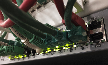 Patch Panel server rack with different colored cords in the backgroundの写真素材