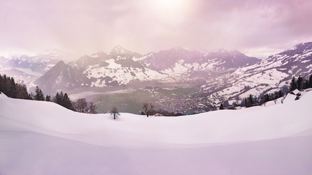 panoramic view over the swiss alps in winter during sunsetの写真素材