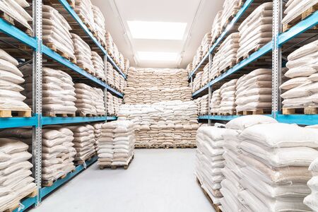 clean and open warehouse stacked with white sacksの写真素材