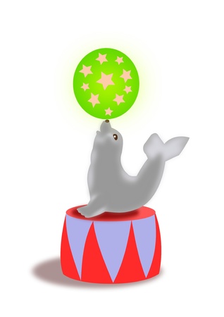 A seal balancing a green ball with stars on his nose の写真素材