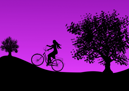 A girl bicycles at dusk and some large trees の写真素材