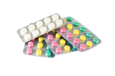 Blisters with multicolor tablets isolated on white background