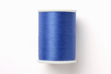Spindle of blue thread