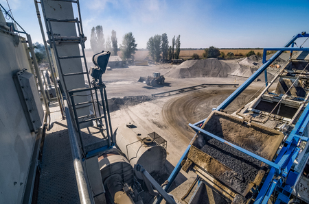 Mobile asphalt-concrete plant. Loader in dust.の写真素材