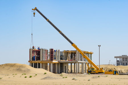 Construction in desert. Yellow crane operation.