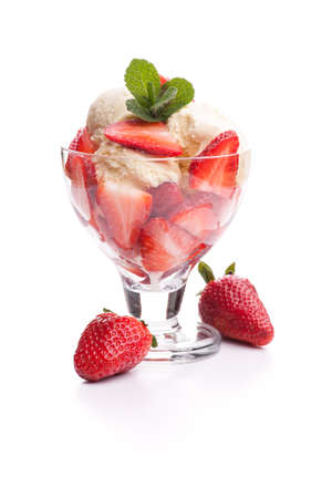 A strawberry sundae with two strawberries. Real edible ice cream isolated on white background, no artificial ingredients used.の写真素材