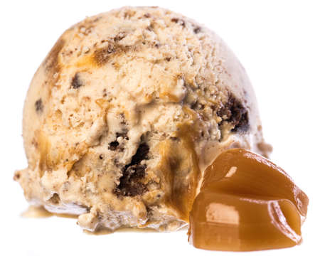 Single scoop of vanilla - caramel - brownie ice cream with caramel pieces isolated on white background front view. Real edible ice cream isolated on white background, no artificial ingredients used.の写真素材