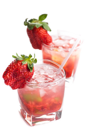 Two cool cocktails with strawberries isolated on white background. Real edible cocktails isolated on white background - no artificial ingredients used.の写真素材