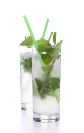 Two mojitos isolated on white background. Real edible cocktails isolated on white background - no artificial ingredients used.の写真素材