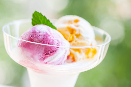 Two different scoops of ice cream in a glass bowl
