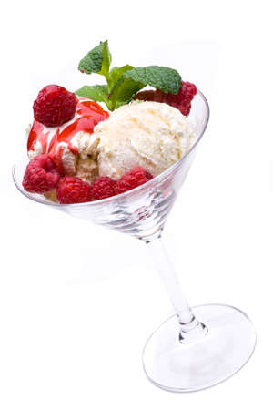 ice cream sundae with red fruits an mint leaf on white backgroundの写真素材