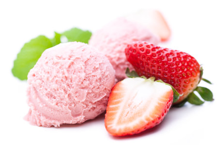 Two scoops of strawberry ice cream with strawberries isolated on white backgroundの写真素材