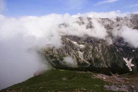 Mountain peaks covered with cloudsの写真素材