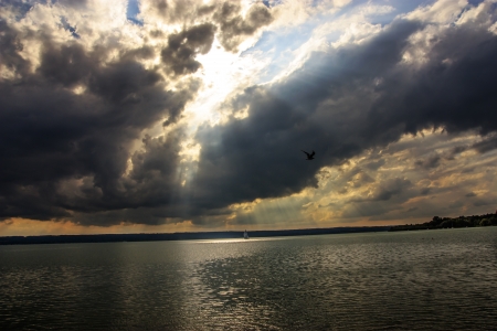 A boat on the lake and sky covered with cloudsの写真素材