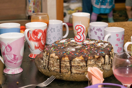 Cake for birthday celebration on table with a few cups for tea coffee tastyの写真素材