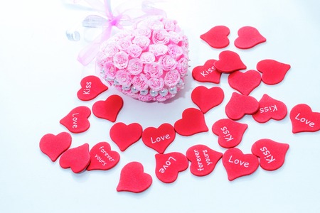 Pink handmade decoration for wedding celebration with heap of red hearts for valentine day background love cardの写真素材