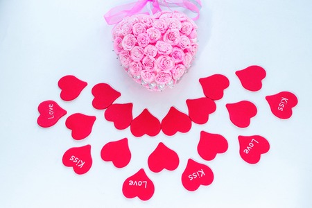 Symbol of love red paper hearts with labels and pink handmade decoration for wedding celebration for valentine day backgroundの写真素材