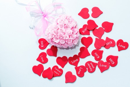 Pink decoration for wedding with bow and red hearts for valentine day backgroundの写真素材