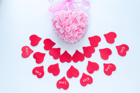 Symbol of love red paper hearts with labels and pink handmade decoration for wedding celebration for valentine day backgroundの写真素材