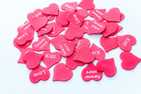 Heap of scattered red hearts with text background white close-up loveの写真素材
