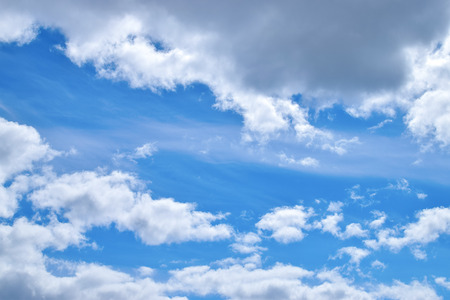 Beautiful fluffy clouds on a blue sky with sunshine natureの写真素材