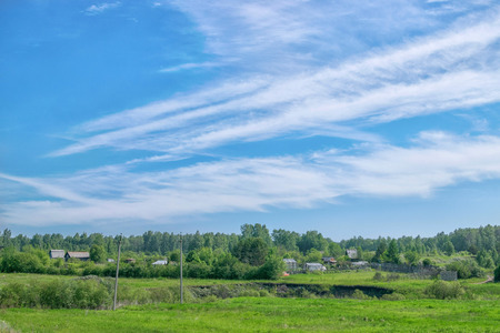 Amazing clouds over the village and forest natureの写真素材