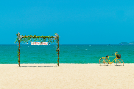 Wooden gate with flowers and old yellow bicycleの写真素材