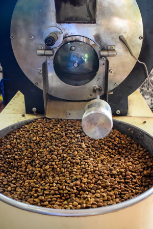 Roasted coffee beans in vintage grinding machineの写真素材