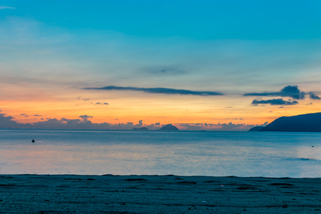 Colorful sky at amazing dawn over ocean on the beachの写真素材