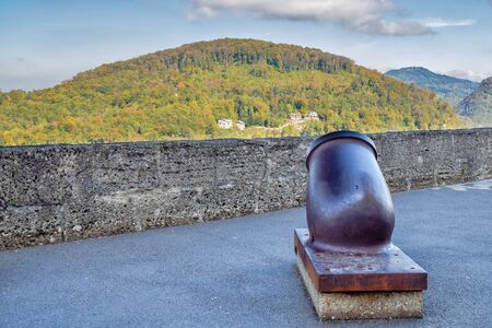 Old rusty metal cannon with nature background in fortress in Salzburg Austria in sunny day at autumnの写真素材