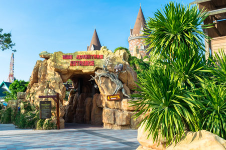 NHA TRANG, VIETNAM - APRIL 16, 2019: Entrance to the roller coaster ride in the amusement park with tropical plantsのeditorial素材