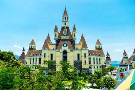 Fairy castle with peak roof with a tropical tree in foreground in the amusement park in Vinpearlのeditorial素材