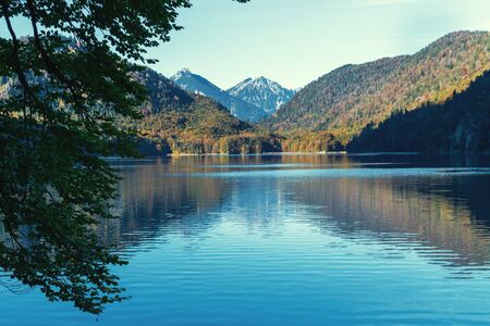 Reflection of a mountain on the surface of lake in the Alps in the morning in autumnの写真素材