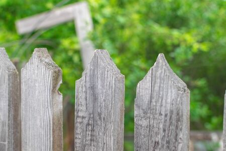 Sharp triangular tops of a wooden fence on a garden in the morning texture woodの写真素材