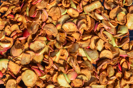 Heap of fresh dried apples under the sunlights outside in autumn
