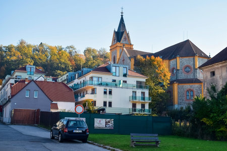 PRAGUE, CZECH REPUBLIC - OKTOBER 11, 2018: Ancient church and modern house in Europe and yellow...