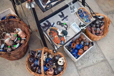 PRAGUE, CZECH REPUBLIC - OKTOBER 11, 2018: Souvenir mugs and buttons in shop on market in baskets...