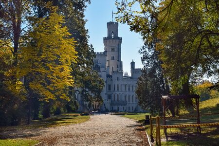 Old castle in the Czech Republic between yellow trees in the autumn morningの写真素材
