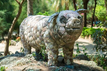 Ancient shell pig statue in parkの写真素材